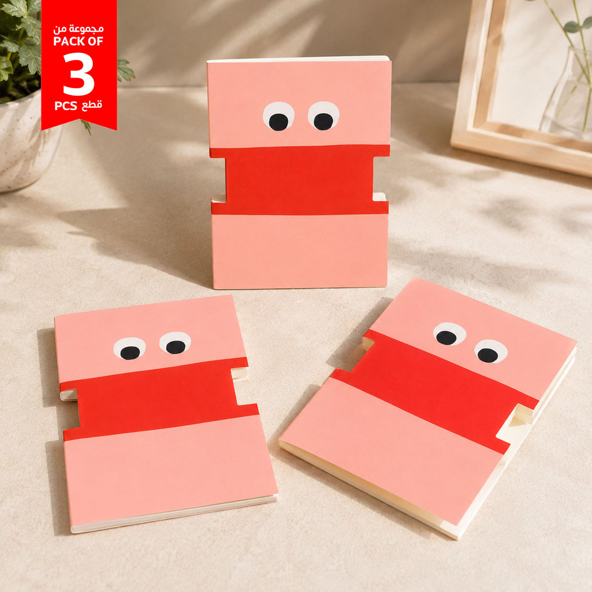 Set of 3 cartoon face notebooks, pink-red covers with big eyes, stacked view