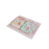 Two mini cartoon notebooks with keychain charms, pastel covers with fruit and bunny art
