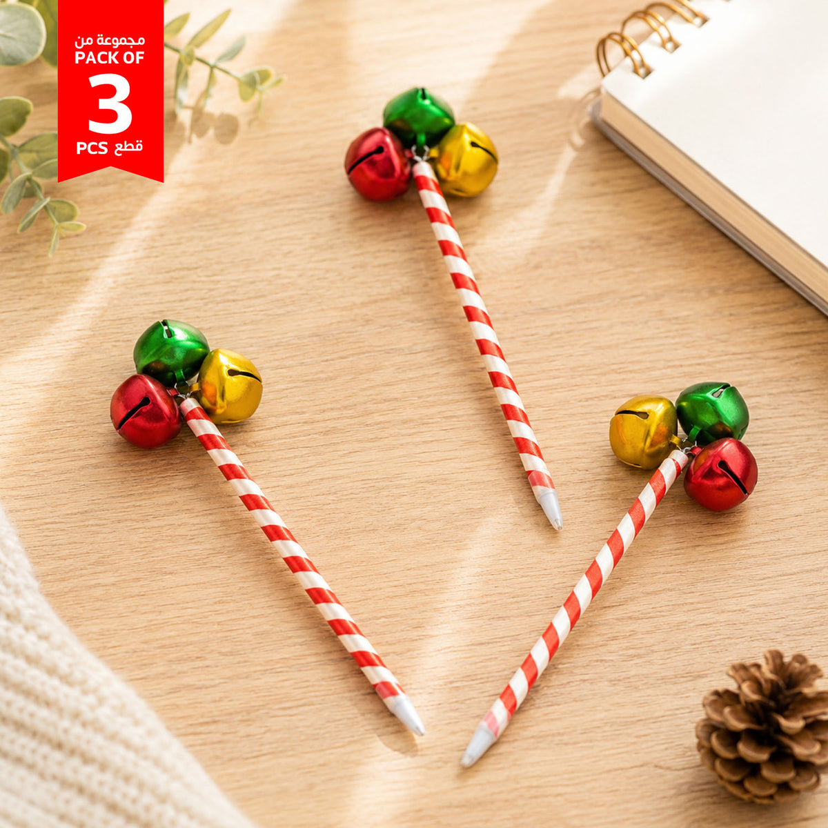 Set of 3 holiday jingle bell pens with red-and-white striped barrels and gold, green, red bells
