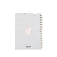 White spiral notebook cover with small bear icon and gold coil binding