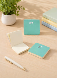 Green emoticon mini notepad set, one open, with sad face graphic