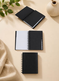 Set of 2 small black spiral notebooks with one open to lined pages