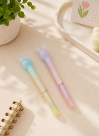 Pastel bunny-ear pen set with two mint and lavender pens on a desk, plus pale yellow and pink.