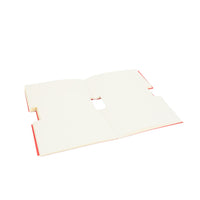 Open cartoon face notebook showing blank white pages and red interior edges