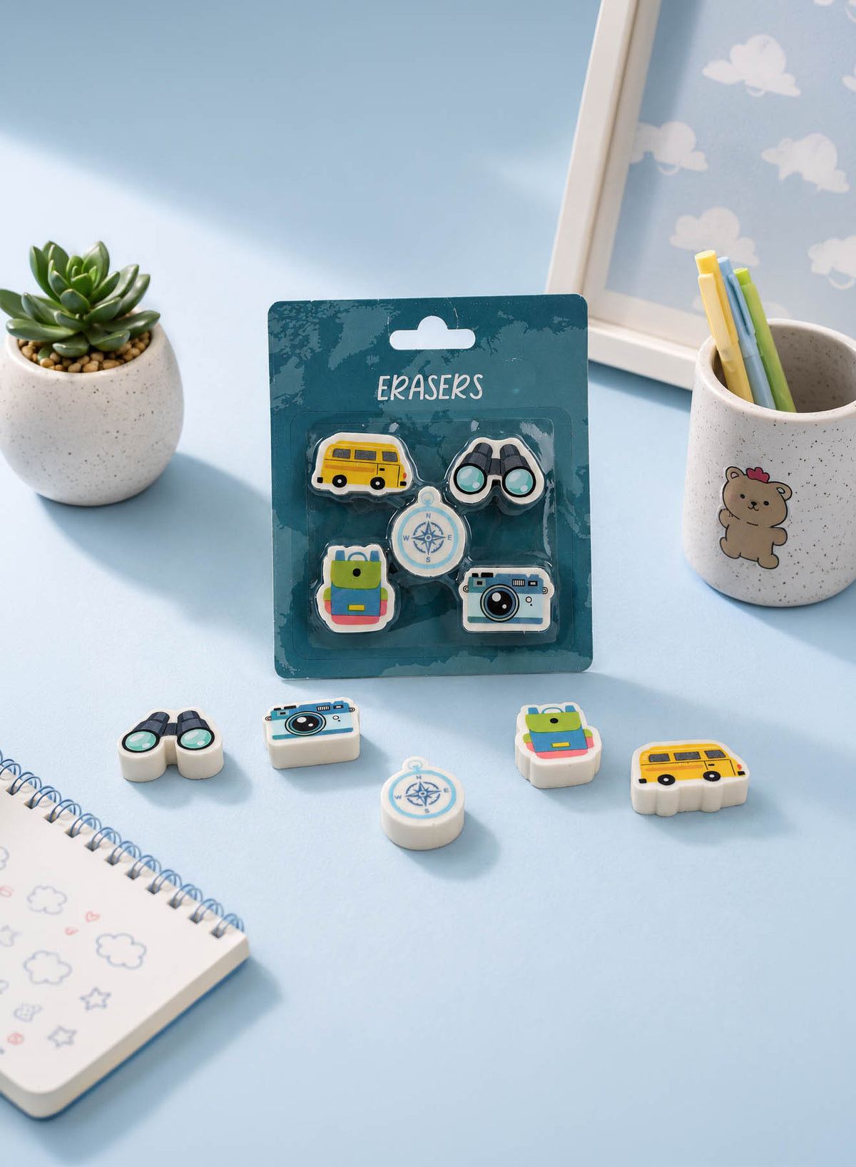 Travel-themed eraser blister pack with small shaped pieces in bus, camera, compass designs