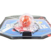 Mini basketball hoop set with orange basketball under clear cover and attached net