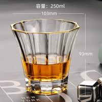 Glass cup with gold-trim rim, filled with amber liquid, 250 ml size