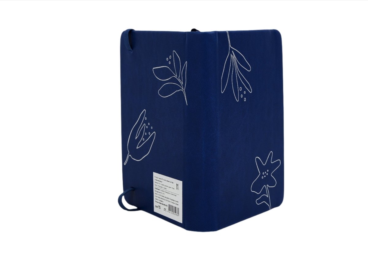 Navy botanical notebook with line-art plants on fabric cover and label sticker