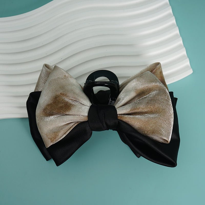 Metallic color bow hair clip with layered satin bows and black center clasp