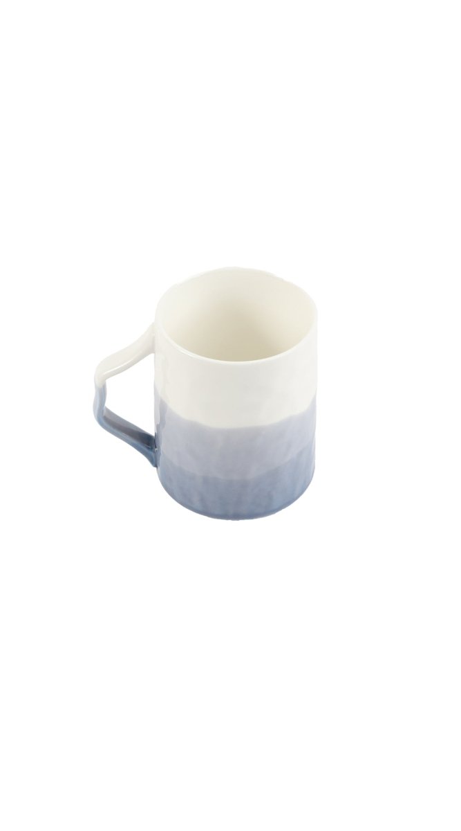 Ceramic cup with soft gradient finish and curved handle, light blue and white.