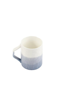 Ceramic cup with soft gradient finish and curved handle, light blue and white.