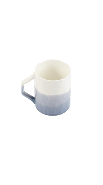 Ceramic cup with soft gradient finish and curved handle, light blue and white.