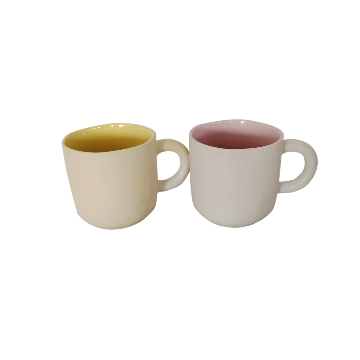 Pair of ceramic cups, one cream with yellow interior and one cream with pink interior