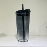 Dark reusable coffee cup with lid and straw, clear lower section