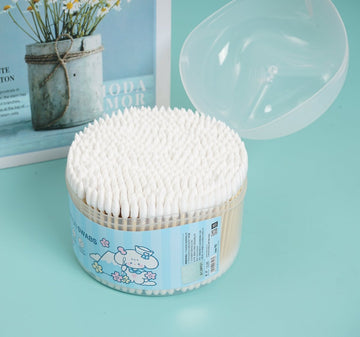 Cotton swabs dispenser with white swabs in a round blue-labeled plastic container