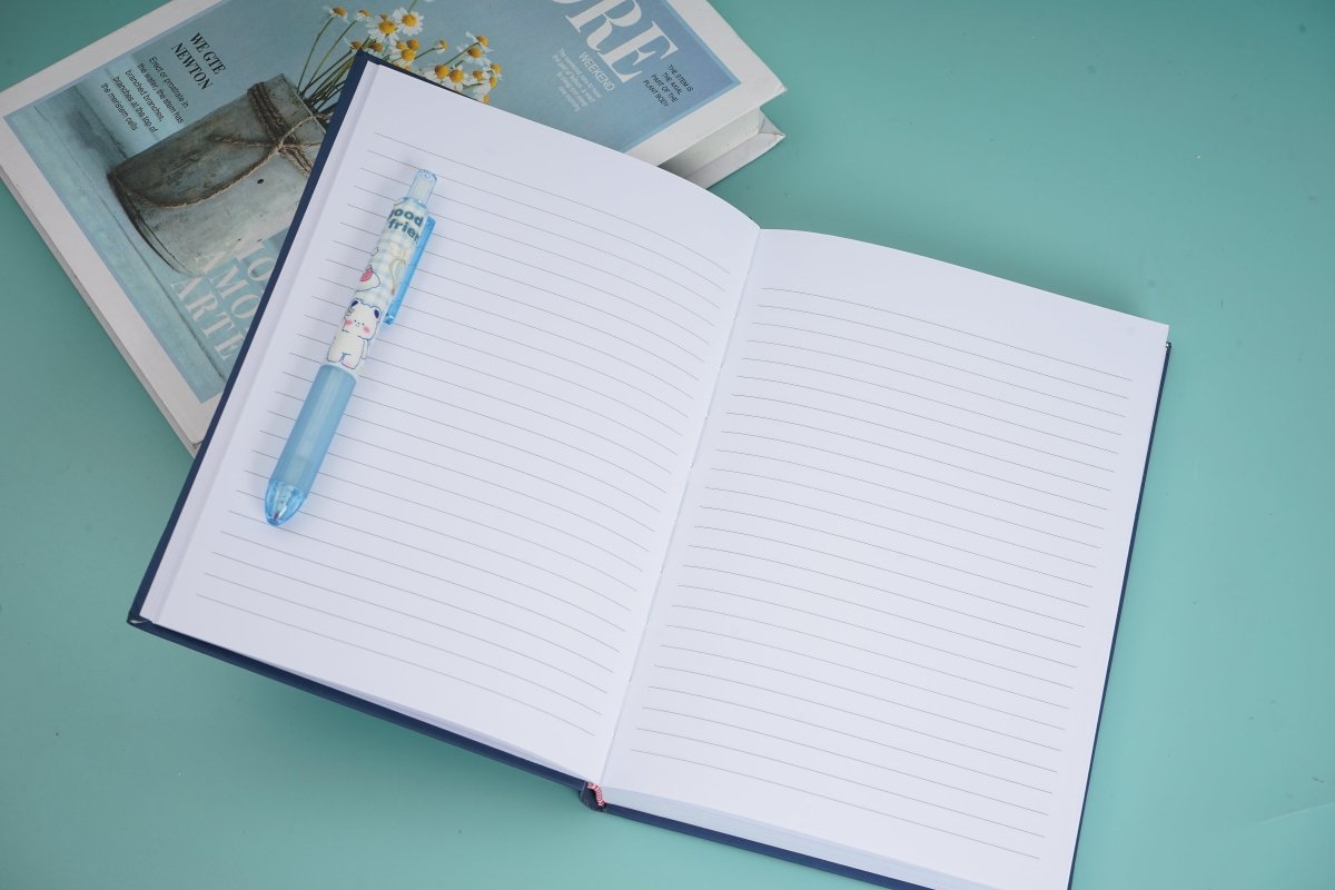Hardback daily planner notebook, open with lined pages and red ribbon marker