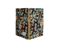 Hardcover spiral notebook with floral cover, gold rings, side/back view showing spine.