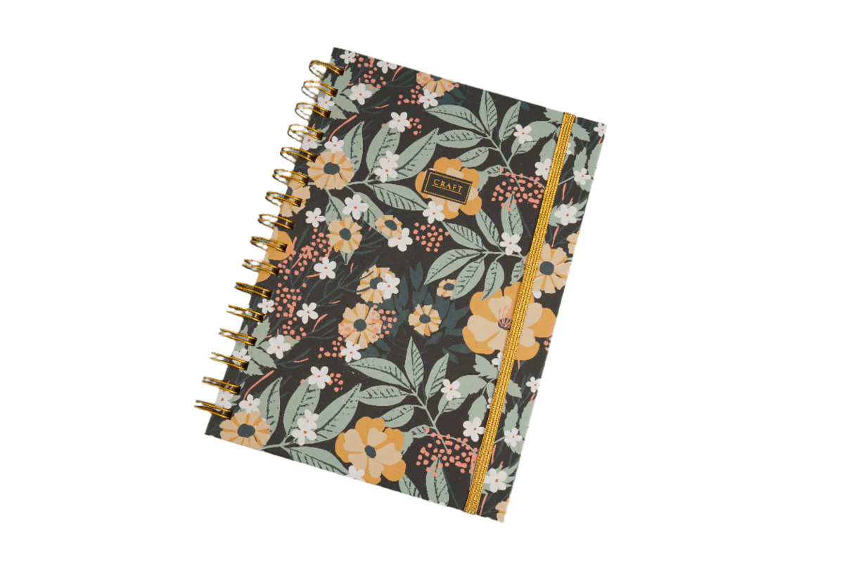 Hardcover spiral notebook with dark floral cover and gold ring binding, front view.