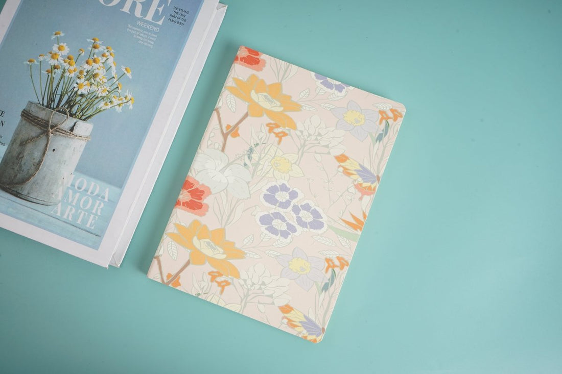 A5 notebook with cream cover and orange-brown floral pattern, soft matte finish
