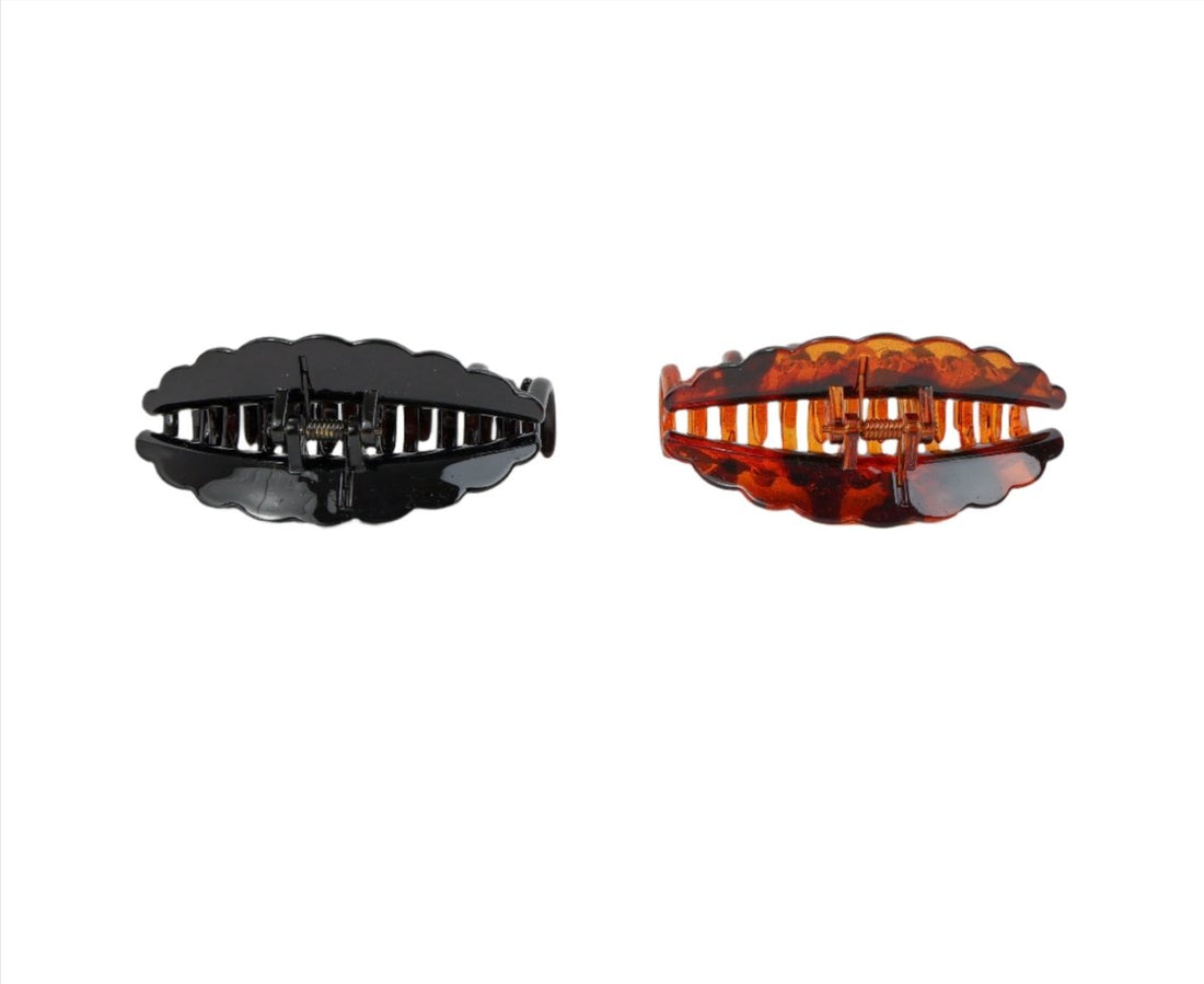 Plastic hair clips, side view; black and brown curved claw grips