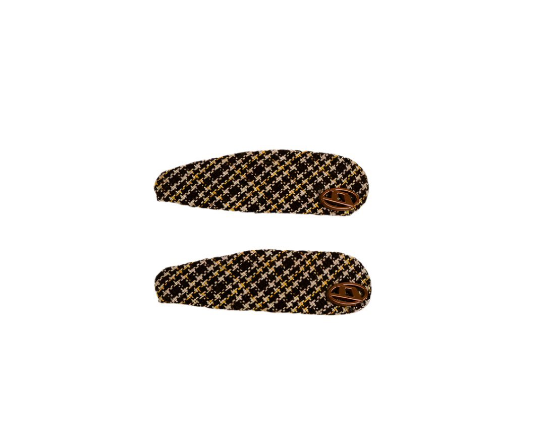 Pair of woven hair clips with houndstooth pattern and decorative button, side view