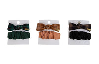 Set of hair bands in packages: green plaid bow, peach plaid bow, and black bow.