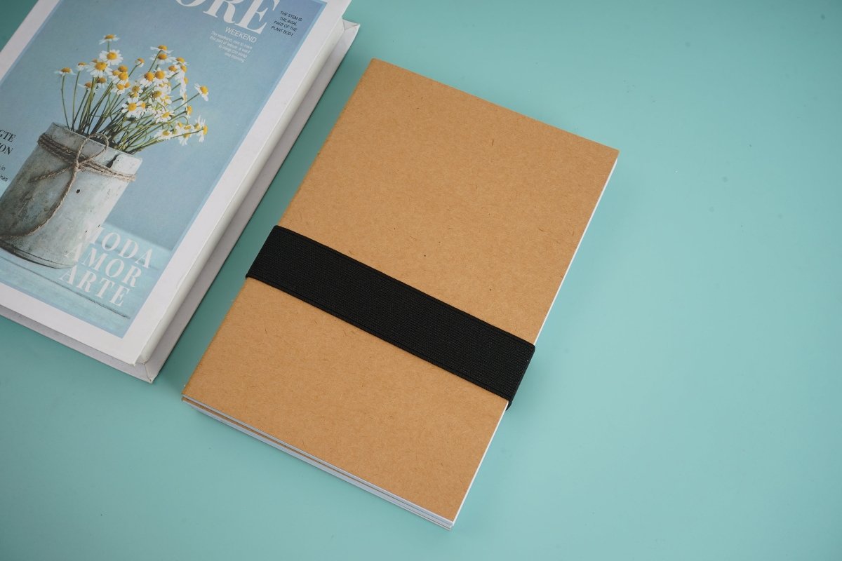 Kraft notebook with black elastic strap and brown cover, closed