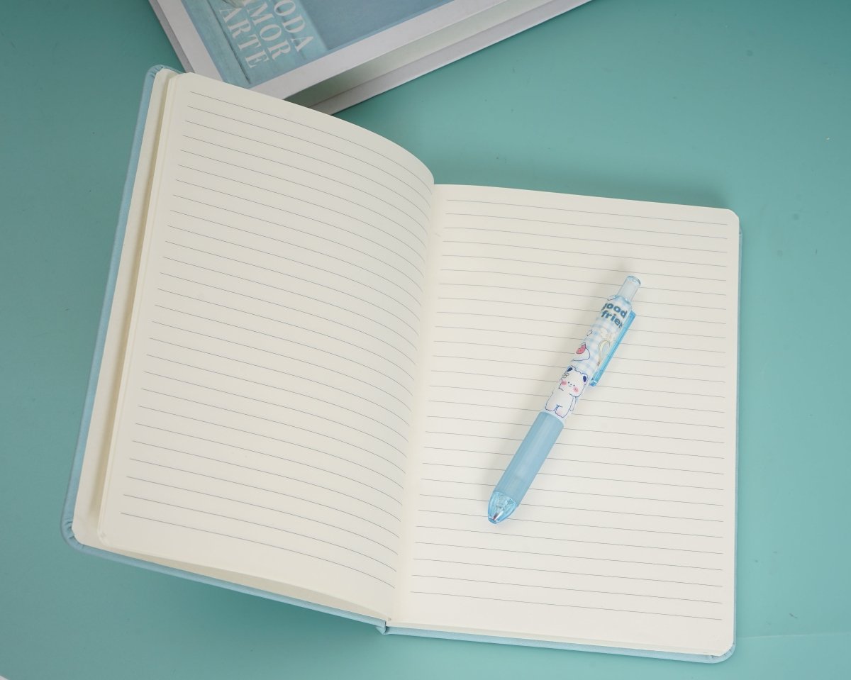 A5 notebook open with lined pages and a blue pen resting on the right page.