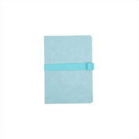 A5 notebook with light green PU plastic cover and teal wrap strap, closed.