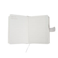 Pastel paper notebook opened flat, lined pages and magnetic buckle closure
