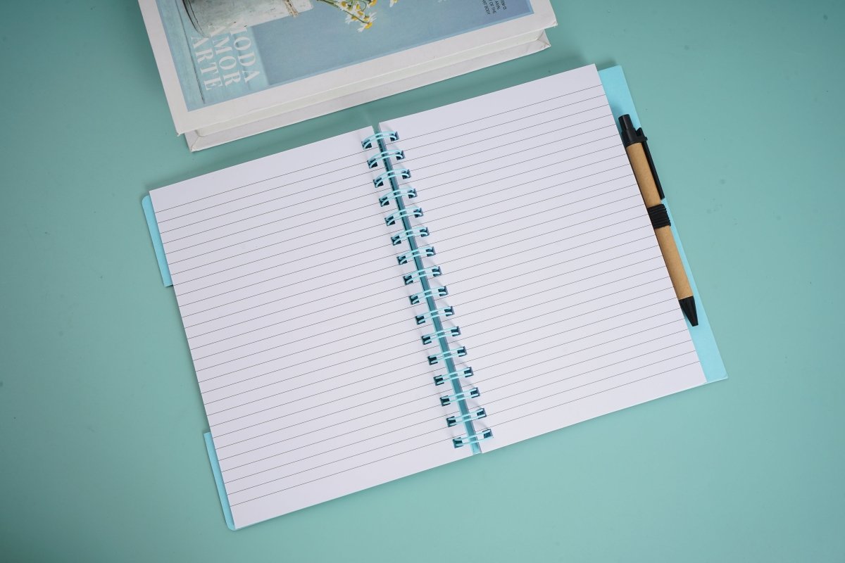 Spiral notebook with pen, open to lined pages