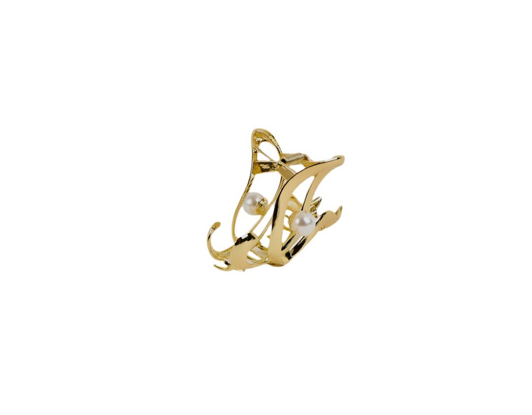 Gold hair clip with two pearl accents and openwork swirl frame