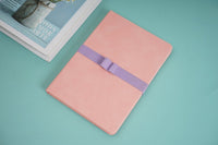 A5 PU notebook, pink cover with purple band, closed at an angle