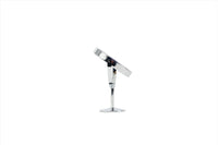 Round makeup mirror with tilting head, chrome stand, and round base, angled view.