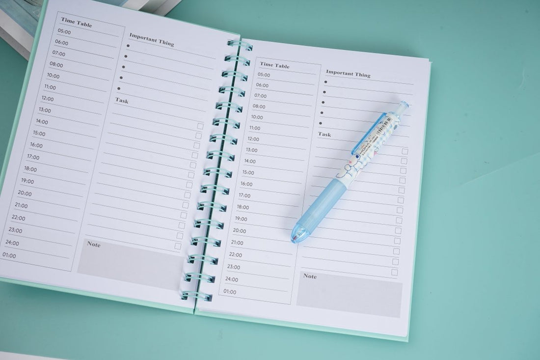 A5 daily planner notebook with turquoise coil binding and printed weekly schedule pages