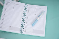 A5 daily planner notebook with turquoise coil binding and printed weekly schedule pages