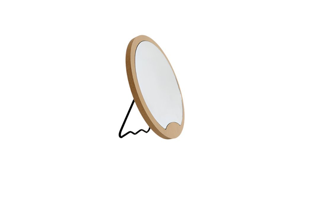 Round wooden mirror with light wood frame in angled view and triangular support