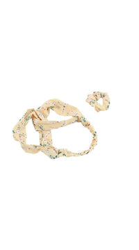 Floral patterned hair headband with matching scrunchie, angled view