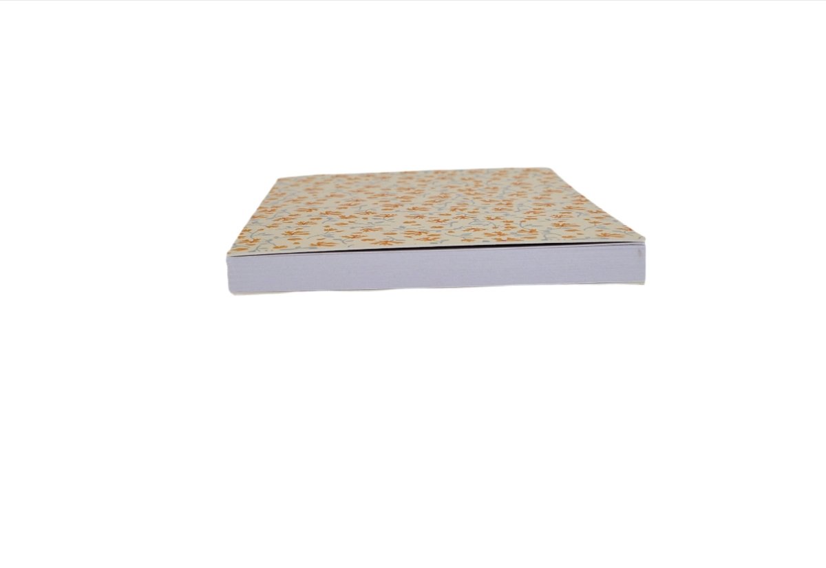 Closed notebook with floral top cover and gray sides