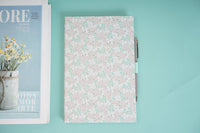 Floral notebook with pink-speckled cover