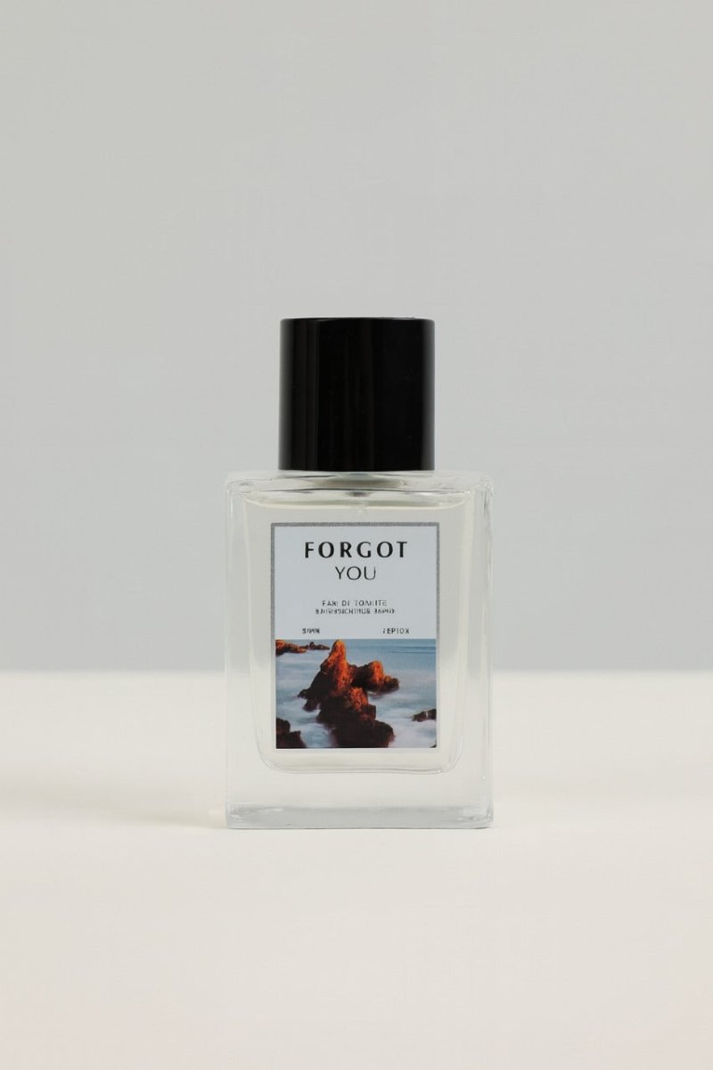Forgot You eau de toilette bottle with black cap, clear glass and seascape label