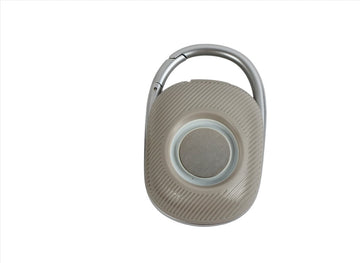 Gray portable wireless speaker with carry handle and circular control button