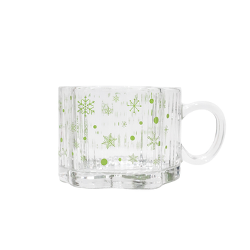 Clear glass mug with green snowflakes and dots, rounded handle