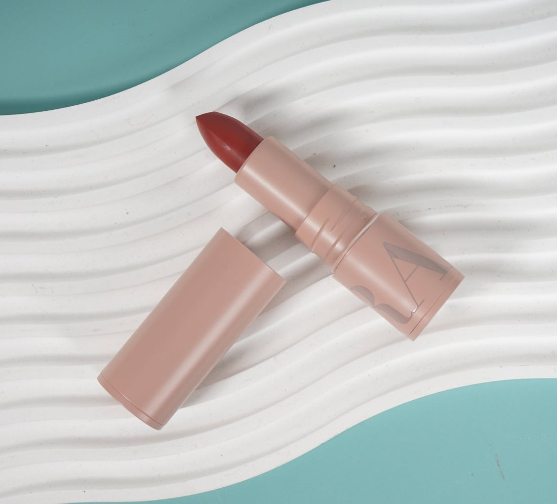 Hydrating long-lasting lipstick in pink tube with red bullet and open cap