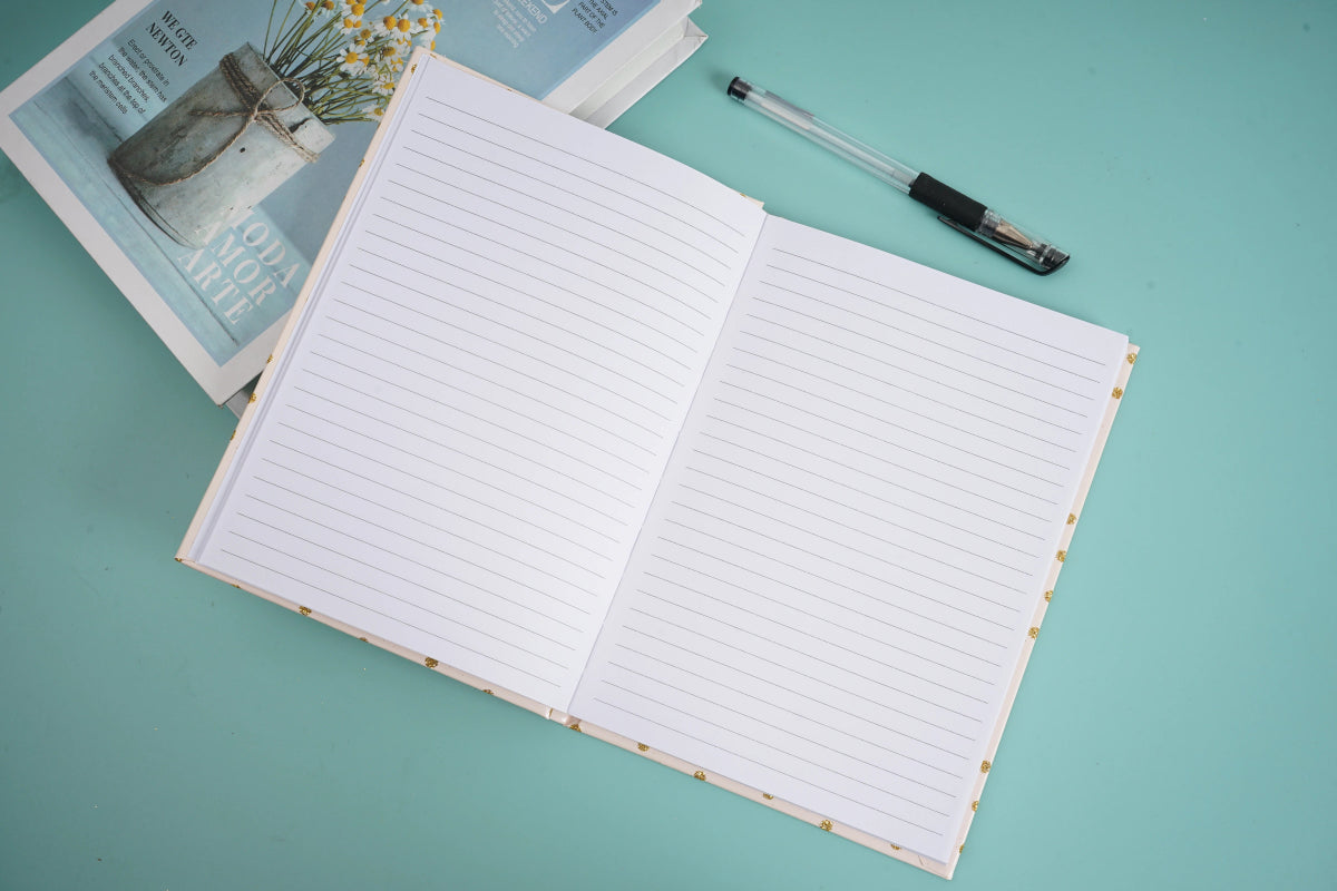 Open notebook with lined pages and pen resting on top