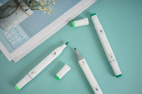 Green highlighter markers, three pens with white barrels and green chisel tips