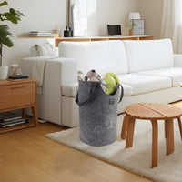 Grey felt laundry basket with tree motif, open top, holding stuffed toys