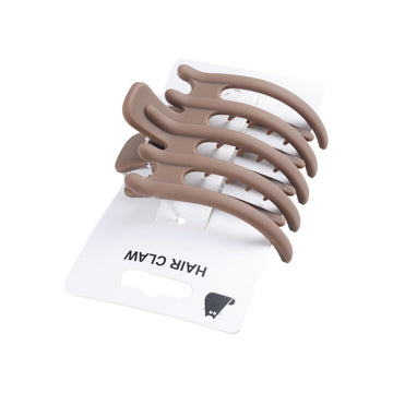Taupe hair claw with four curved prongs on plastic card backing