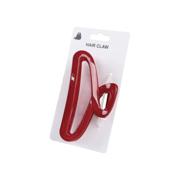 Red plastic hair claw clip on retail card, looped teeth for hold
