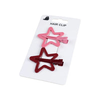 Two star hair clips on a card, pink and dark red